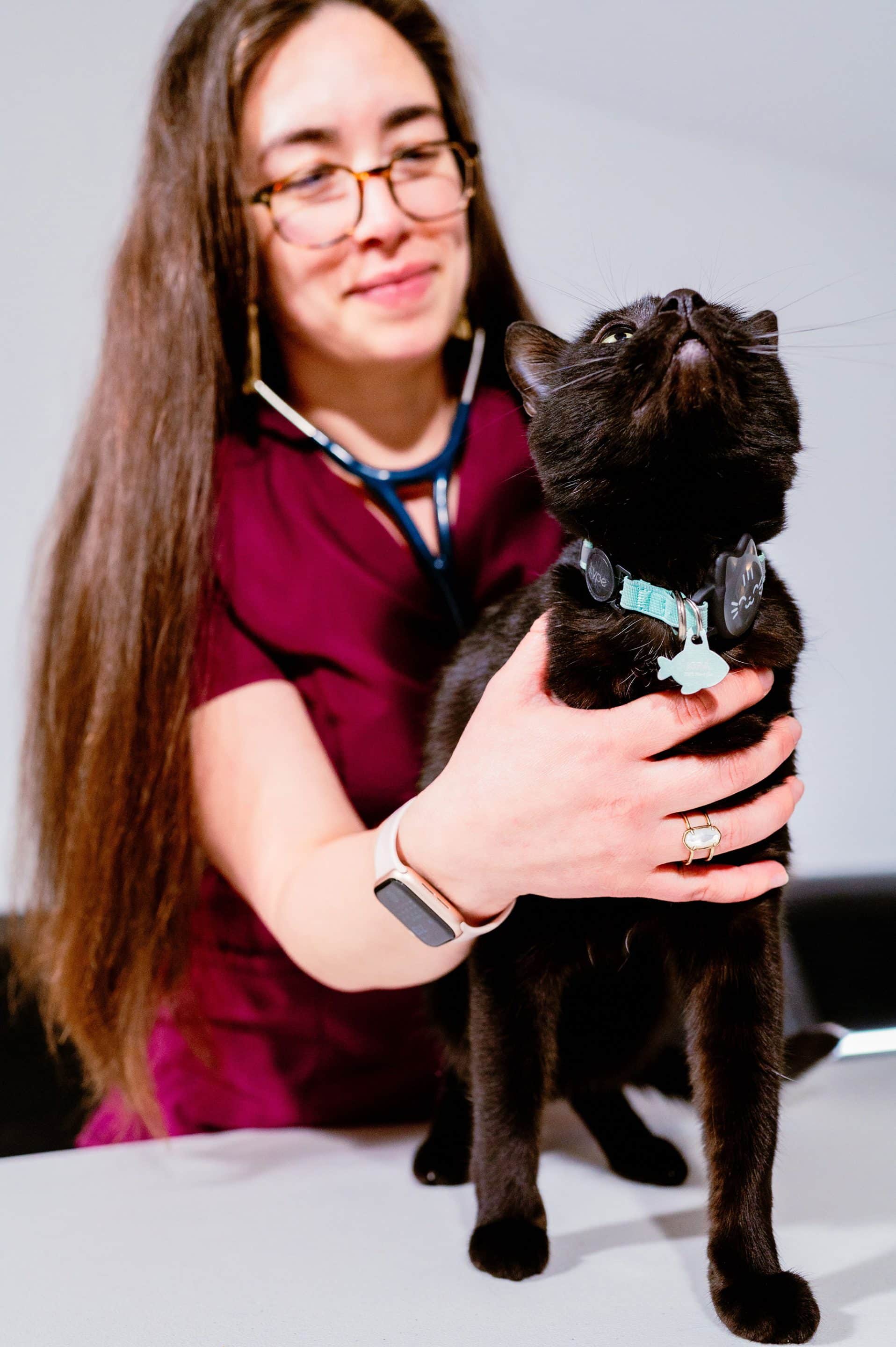 DR. ERICA LOZOYA with a black cat at meow bark